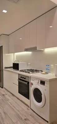 a kitchen with a stove and a washing machine at Studio Apartment Near downtown Dubai in Dubai