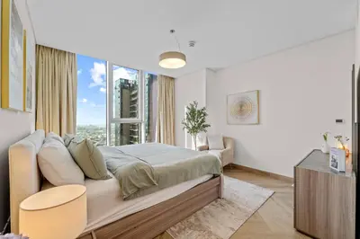 a bedroom with a bed and a large window at Luxury 2 BR Spectacular Downtown and Sea View next to metro in Dubai