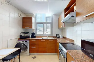 a kitchen with a sink and a washing machine at Cozy Studio in Dubai Marina in Dubai