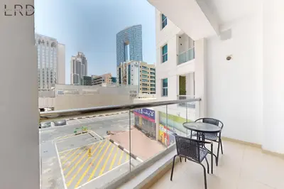 a balcony with a table and chairs and a view of a city at Cozy Studio in Dubai Marina in Dubai