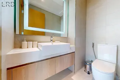 a bathroom with a sink and a toilet at Modern 1BR with Canal View in Dubai