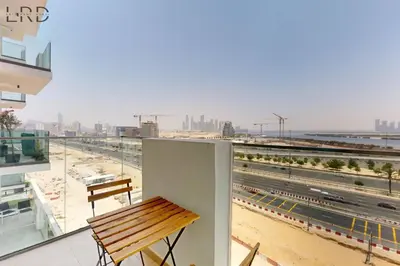 a balcony with a bench and a view of a city at Cozy 1BR with Canal View in Dubai