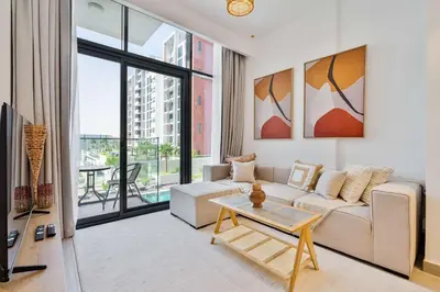 a living room with a couch and a table at PVH - Chic 1BR in Azizi Riviera 37 in Dubai