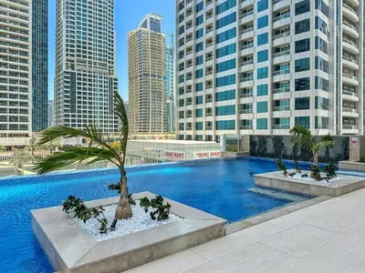 a large swimming pool in a city with tall buildings at PVH - Chic Furnished Studio in JLT - Me Do Re in Dubai