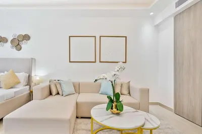 a living room with a couch and a table at PVH - Chic Furnished Studio in JLT - Me Do Re in Dubai