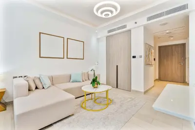 a white living room with a couch and a table at PVH - Chic Furnished Studio in JLT - Me Do Re in Dubai