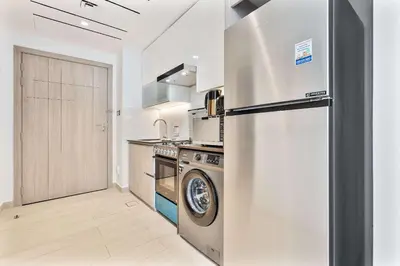 a kitchen with a stainless steel refrigerator and a dishwasher at PVH - Chic Furnished Studio in JLT - Me Do Re in Dubai