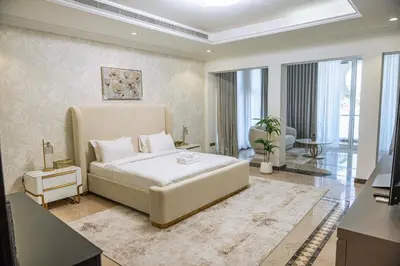 a bedroom with a large bed in a room at Luxury Palm Villa with direct private beach access in Dubai