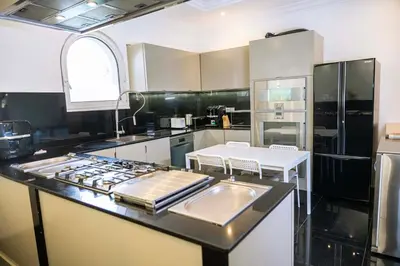 a kitchen with a sink and a stove top oven at Luxury Palm Villa with direct private beach access in Dubai