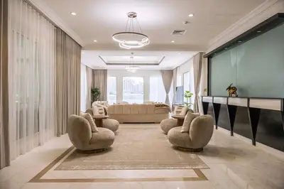 a large living room with chairs and a couch at Luxury Palm Villa with direct private beach access in Dubai