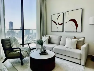 a living room with a couch and a table at Aesthetic 1br In Binghatti House Free Pool Gym in Dubai