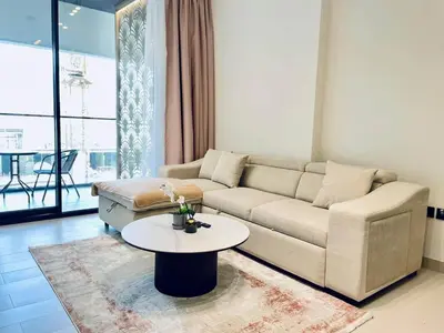 a living room with a couch and a table at Velvet 1br Serenity Pool View & Free Amenities! in Dubai