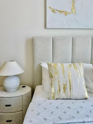 a bedroom with a bed with a lamp on a night stand at Sky 2br Sanctuary With Plunge Pool Gym Parking! in Dubai