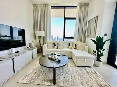 a living room with a couch and a table at Sky 2br Sanctuary With Plunge Pool Gym Parking! in Dubai
