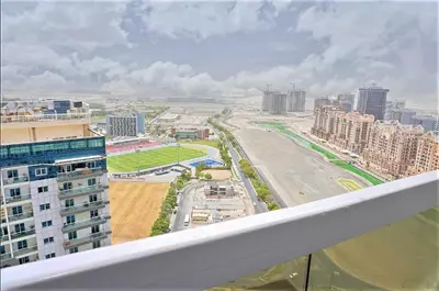 a view of a city from the balcony of a building at Luxury Studio Pool & Gym Access in Dubai Sports City in Dubai