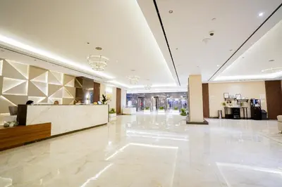 a lobby of a hotel with a reception desk at Luxury Studio Pool & Gym Access in Dubai Sports City in Dubai
