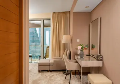 a hotel room with a desk and a couch at Fashion Avenue Dubai Mall in Dubai