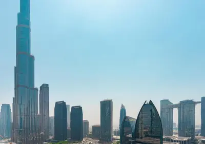 a group of tall buildings in a city at Fashion Avenue Dubai Mall in Dubai