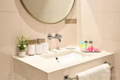 a bathroom with a white sink and a mirror at Luxury 2 Bedroom Apartment - Private Beach - Emaar Beach Vista in Dubai