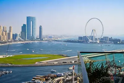 a view of a city with a ferris wheel in the background at Luxury 2 Bedroom Apartment - Private Beach - Emaar Beach Vista in Dubai