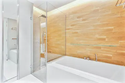 a bathroom with a tub and a glass shower at PVH - Tranquil 2BR - Bluewaters Residences 5 in Dubai