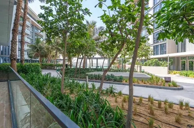 a courtyard with trees and plants in a building at PVH - Tranquil 2BR - Bluewaters Residences 5 in Dubai