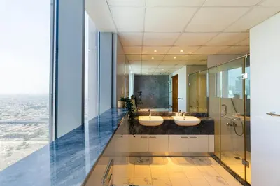 a bathroom with two sinks and a shower at Luxury 4BHK in Business Bay w Burj Khalifa View Noora 4203 in Dubai
