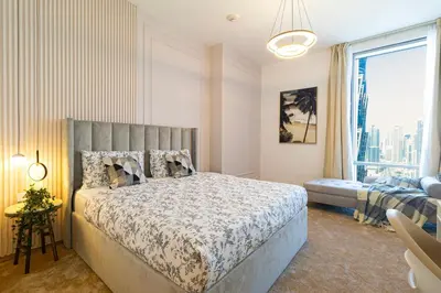 a bedroom with a bed and a large window at Luxury 4BHK in Business Bay w Burj Khalifa View Noora 4203 in Dubai