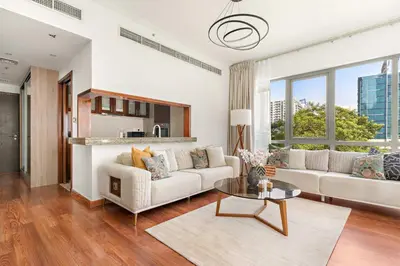 a living room with a white couch and a table at Silkhaus Luxurious 1BDR in Downtown in Dubai