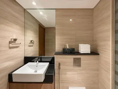 a bathroom with a sink and a mirror at Luxury Studio in Urban Oasis, Business Bay in Dubai