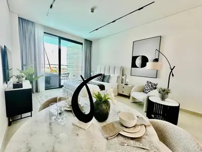 a living room with a couch and a table at Serene Canalfront Studio Apt With Private Jacuzzi! in Dubai