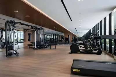 a gym with treadmills and cardio equipment in a building at Serene Canalfront Studio Apt With Private Jacuzzi! in Dubai