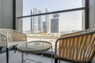 two chairs and a table in front of a window at Waves - Impressive 1BR Apartment Close to Burj Khalifa in Dubai