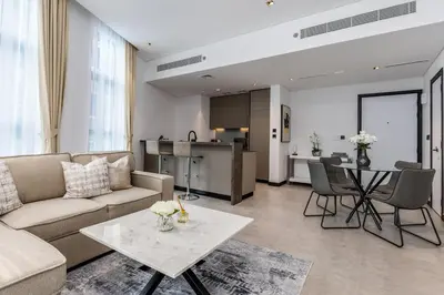 a living room with a couch and a table at Waves - Impressive 1BR Apartment Close to Burj Khalifa in Dubai