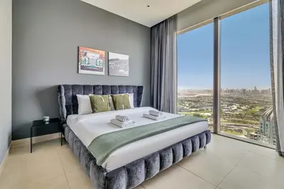 a bedroom with a large bed with a large window at DAYF-MGA Spacious 3Bed with Full Marina View in Dubai