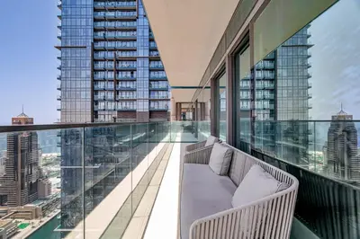a balcony with a couch and views of a city at DAYF-MGA Spacious 3Bed with Full Marina View in Dubai