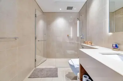 a bathroom with a shower and a toilet and a sink at DAYF-MGA Spacious 3Bed with Full Marina View in Dubai