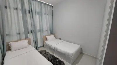 a small room with two beds and a window at Damac hills 2 vardon cluster in Dubai