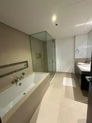 a white bathroom with a tub and a sink at 3403!Dubai SkyLine View! Royal Montania Homes in Dubai