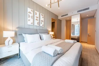 a bedroom with a large bed with two white pillows at Luxurious 1BR Dubai Mall Burj Khalifa View pool in Dubai