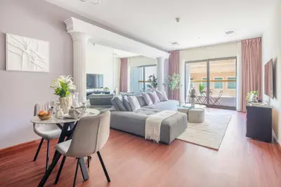 a living room with a couch and a table at Frank Porter - B324 - 5112 Elite Residence in Dubai
