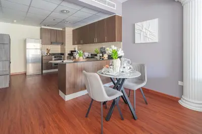 a kitchen with a table and chairs in a room at Frank Porter - B324 - 5112 Elite Residence in Dubai