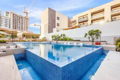 a swimming pool in the middle of a building at Stylish Studio Near Miracle Garden - Luxury Amenities & Style in Dubai