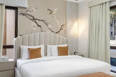 a bedroom with a large white bed with a white headboard at Durrani Homes - Zaafaran Luxe Stay Iconic Burj View in Dubai