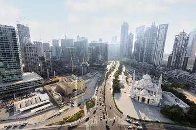 a city with tall buildings and a street with traffic at FIRST CLASS Studio Downtown Bliss Urban Gem in Dubai