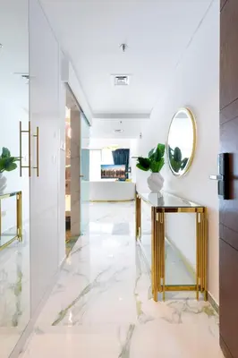 a hallway with a console table and a mirror at FIRST CLASS Studio Downtown Bliss Urban Gem in Dubai