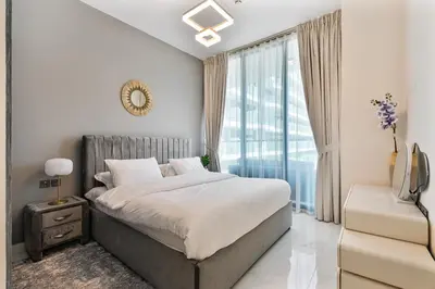 a bedroom with a large bed and a window at Venetian - Relax in your private pool balcony in Dubai in Dubai
