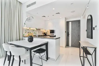 a kitchen and dining room with a table and chairs at Venetian - Relax in your private pool balcony in Dubai in Dubai