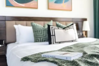 a book sitting on top of a bed at GuestReady - Sea view retreat overlooking The Palm in Dubai