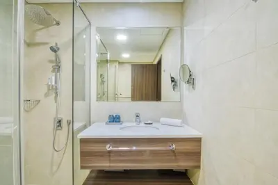 a bathroom with a sink and a shower at GuestReady - Sea view retreat overlooking The Palm in Dubai